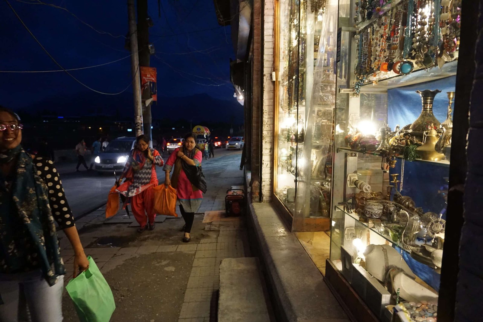 Women shopping at night in a lively street market in Kashmir