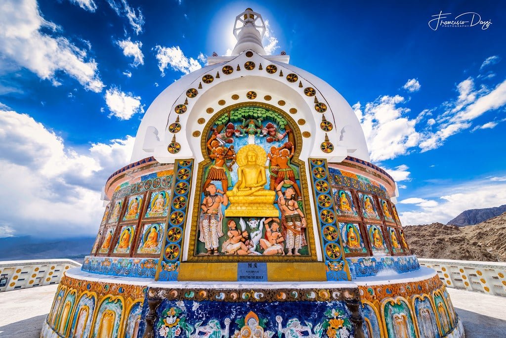 Colorful carvings on Shanti Stupa under a bright blue sky in ladakh