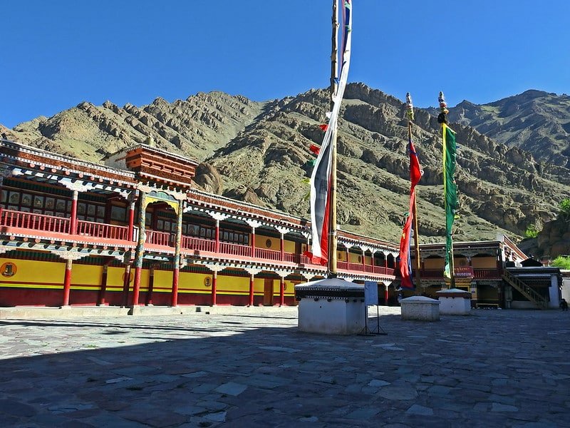 Colorful Hemis monastery monastery courtyard with prayer flags and mountain backdrop