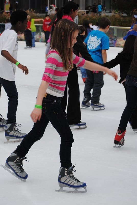 a group of children enjoying ice skating in gulmarg