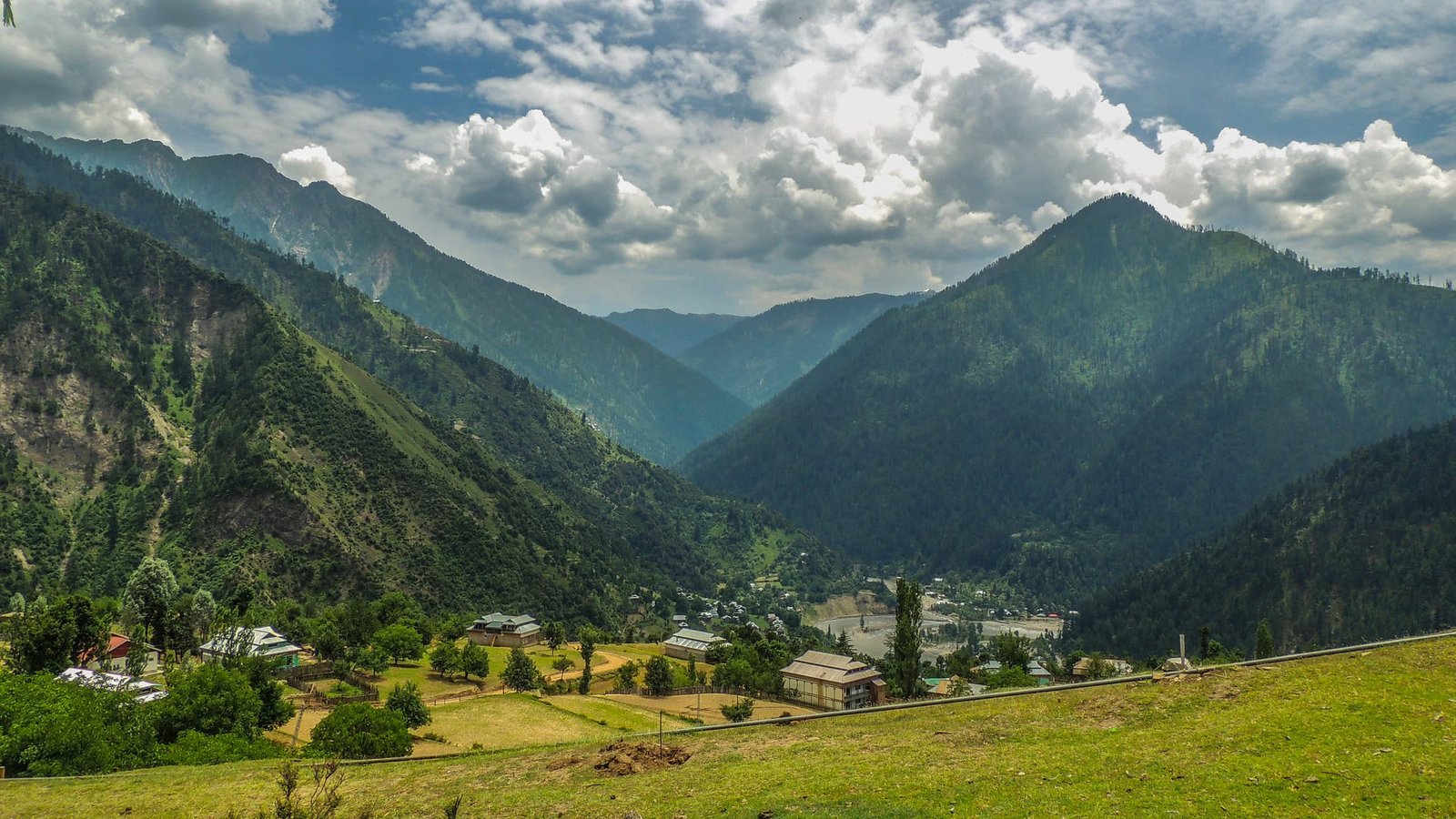 Scenic view of green hills and houses in Keran Valley
