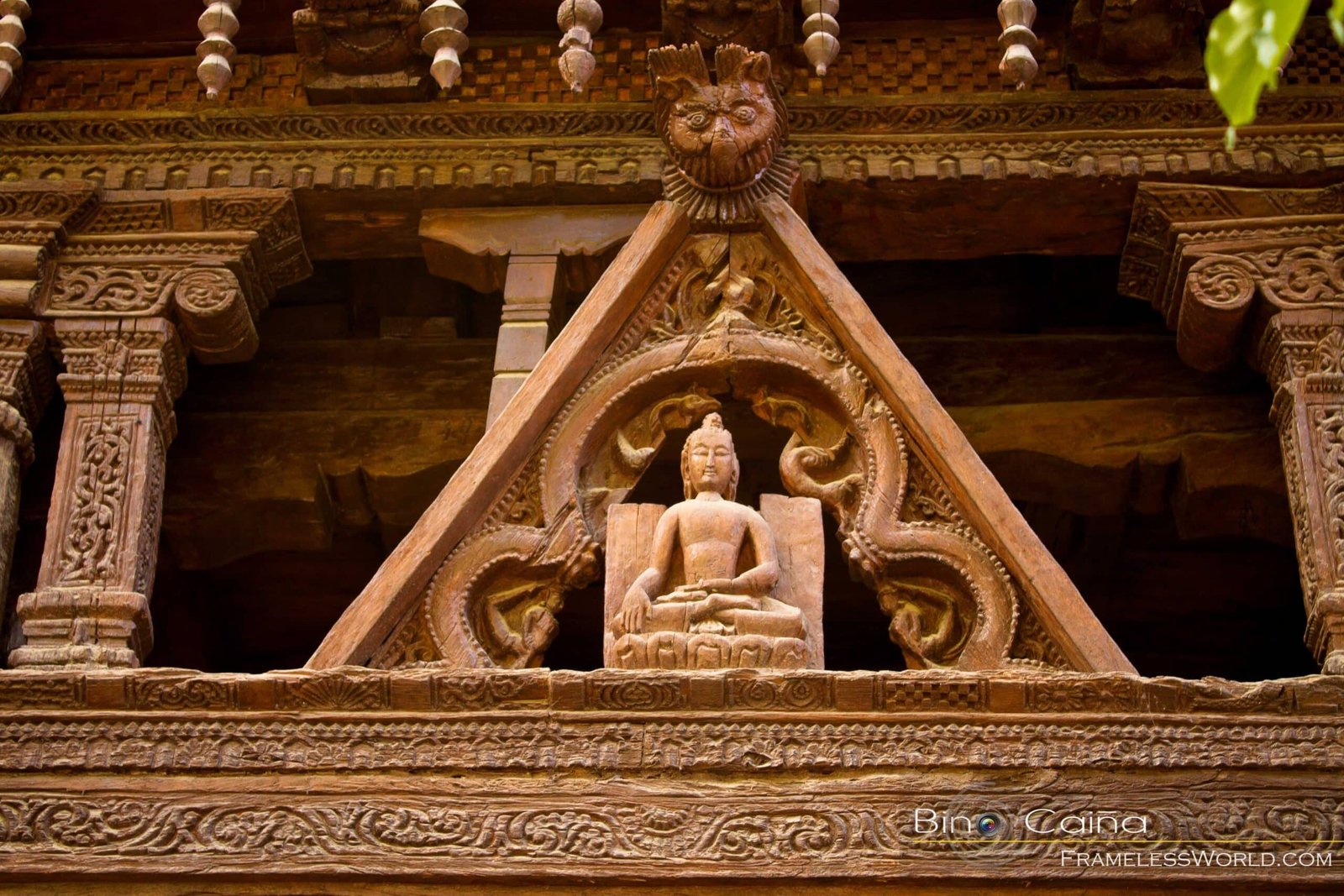 wooden carving of a seated Buddha with decorative patterns around at alchi monastery