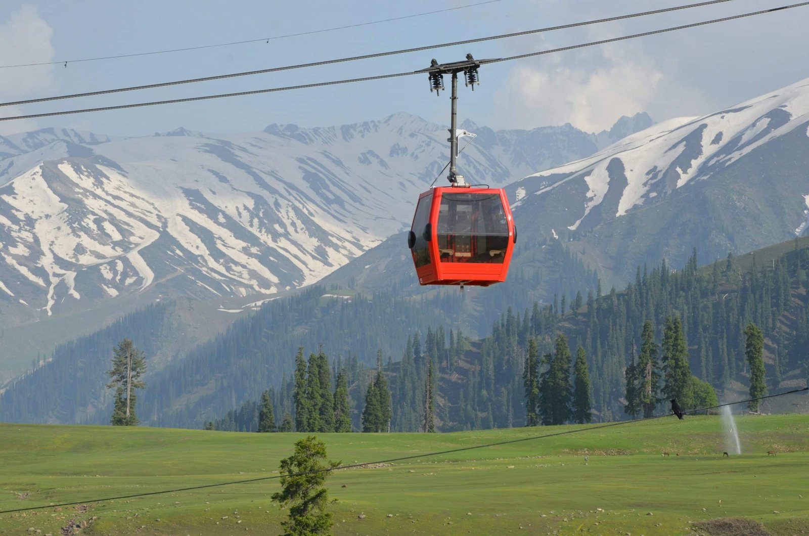tourists enjoying Gondola in the green valley of gulmarg, kashmir