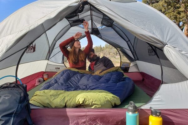 Couple relaxing inside a camping tent in kashmir
