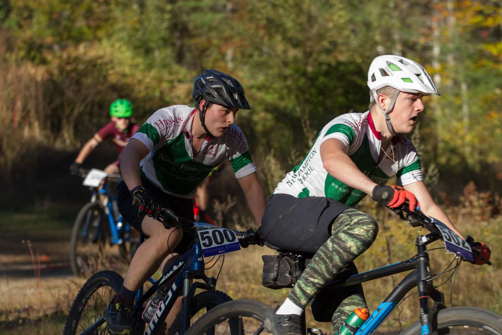 Teenagers racing mountain bikes on a forest trail in kashmir