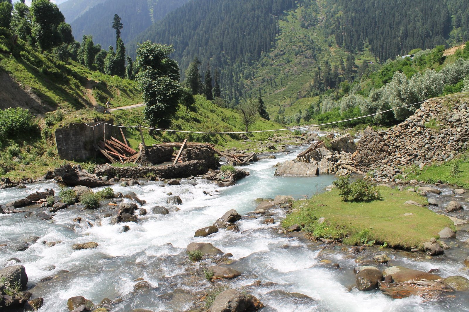 River flowing through Aru Valley with broken bridge remains