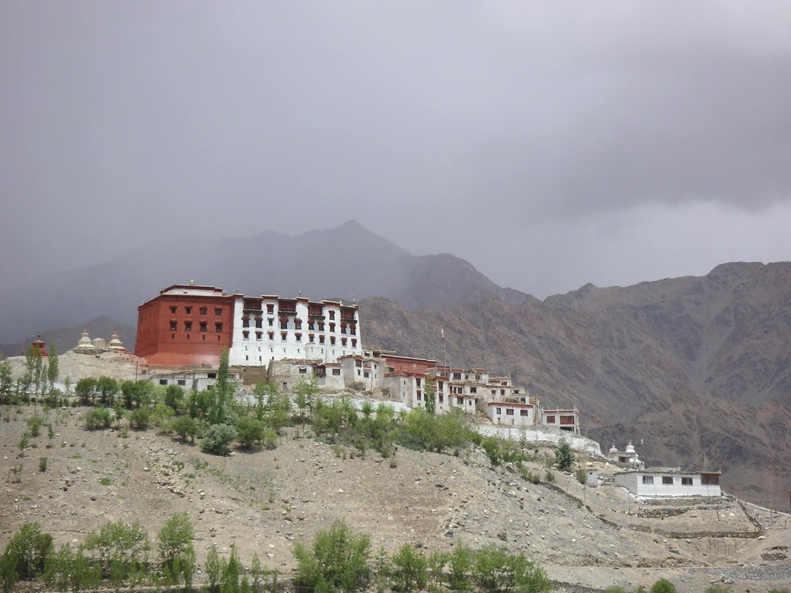 Phyang Monastery with its red and white buildings perched on a hill