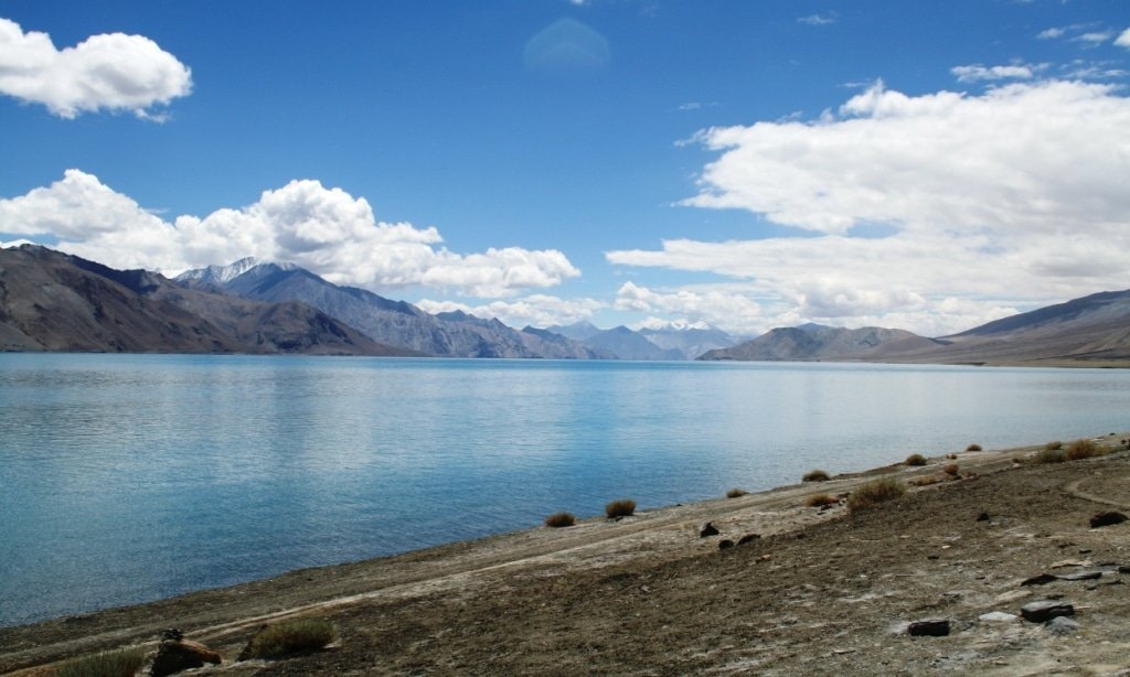 Clear view of Pangong Lake with calm blue water with barren mountains