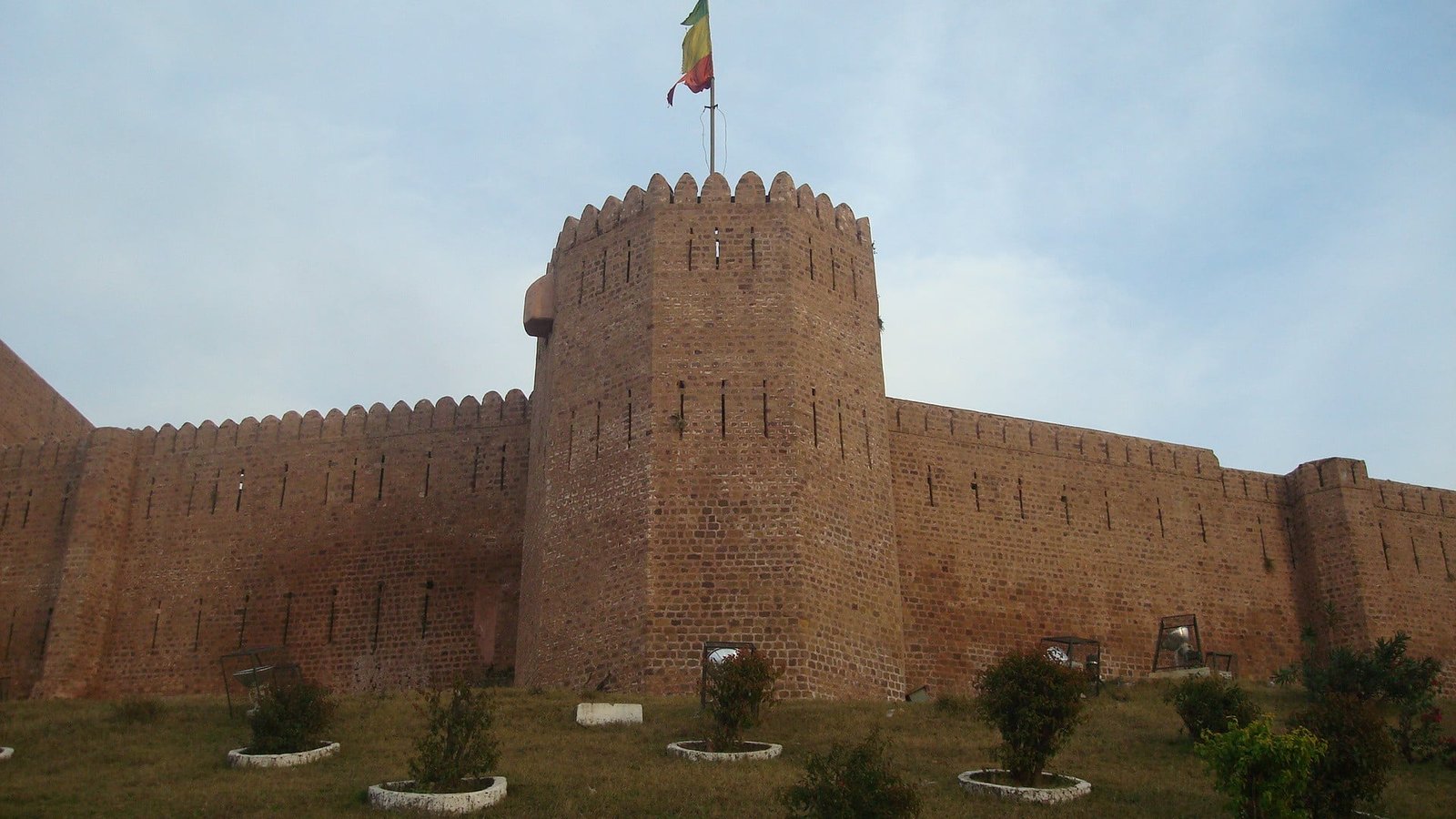 Stone walls and tower of Bahu Fort in Jammu with flag flying above