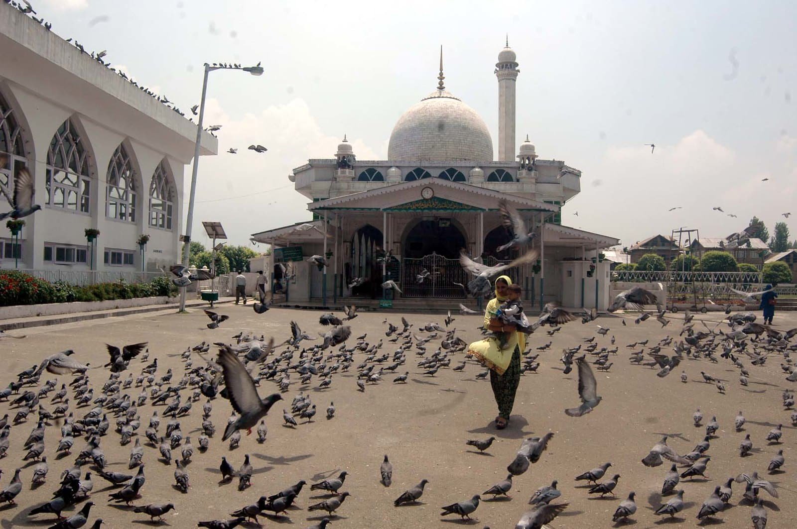 Hazratbal Shrine in Srinagar with pigeons and visitors