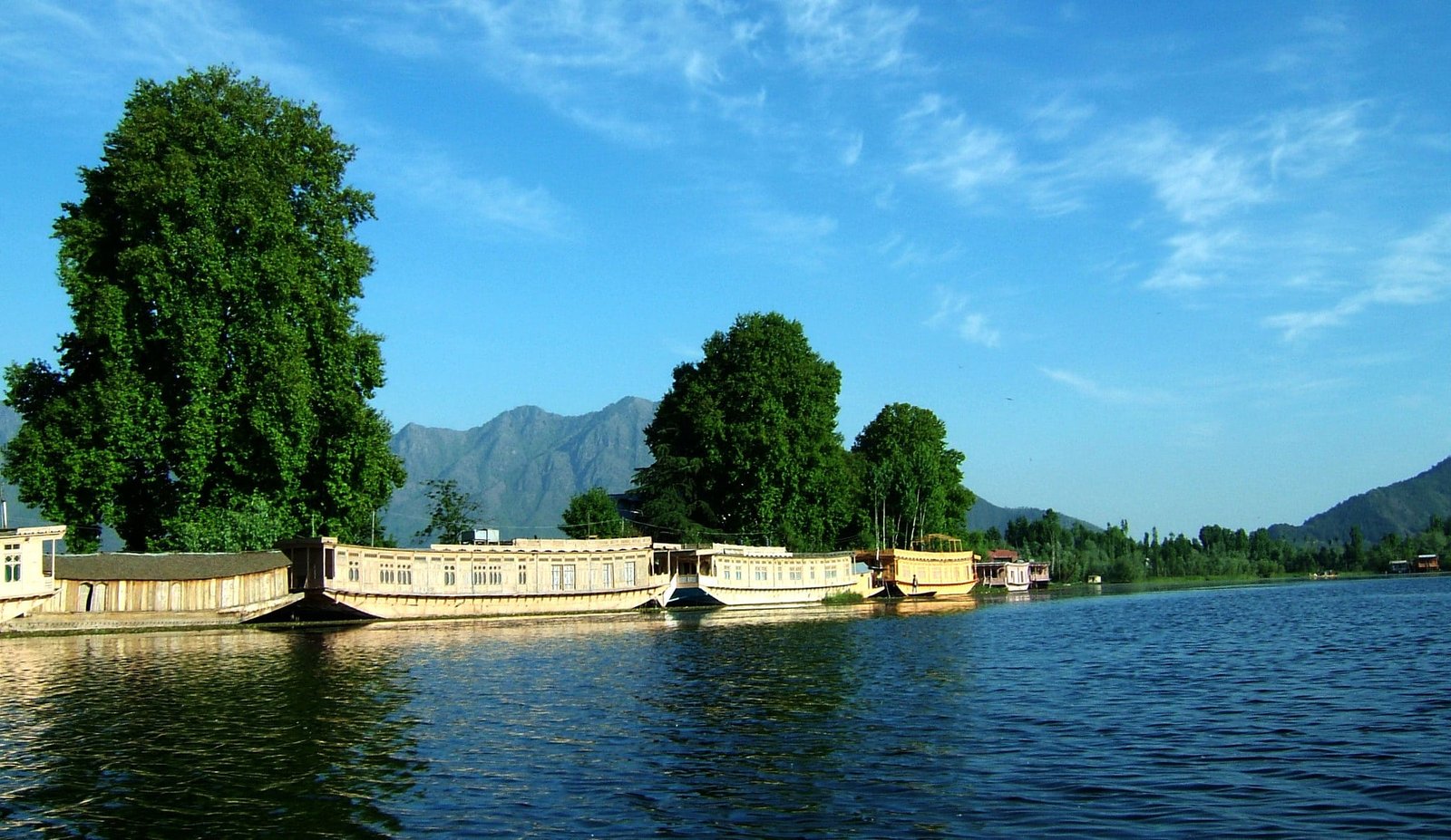 Houseboats on nigeen lake in Srinagar with mountain view