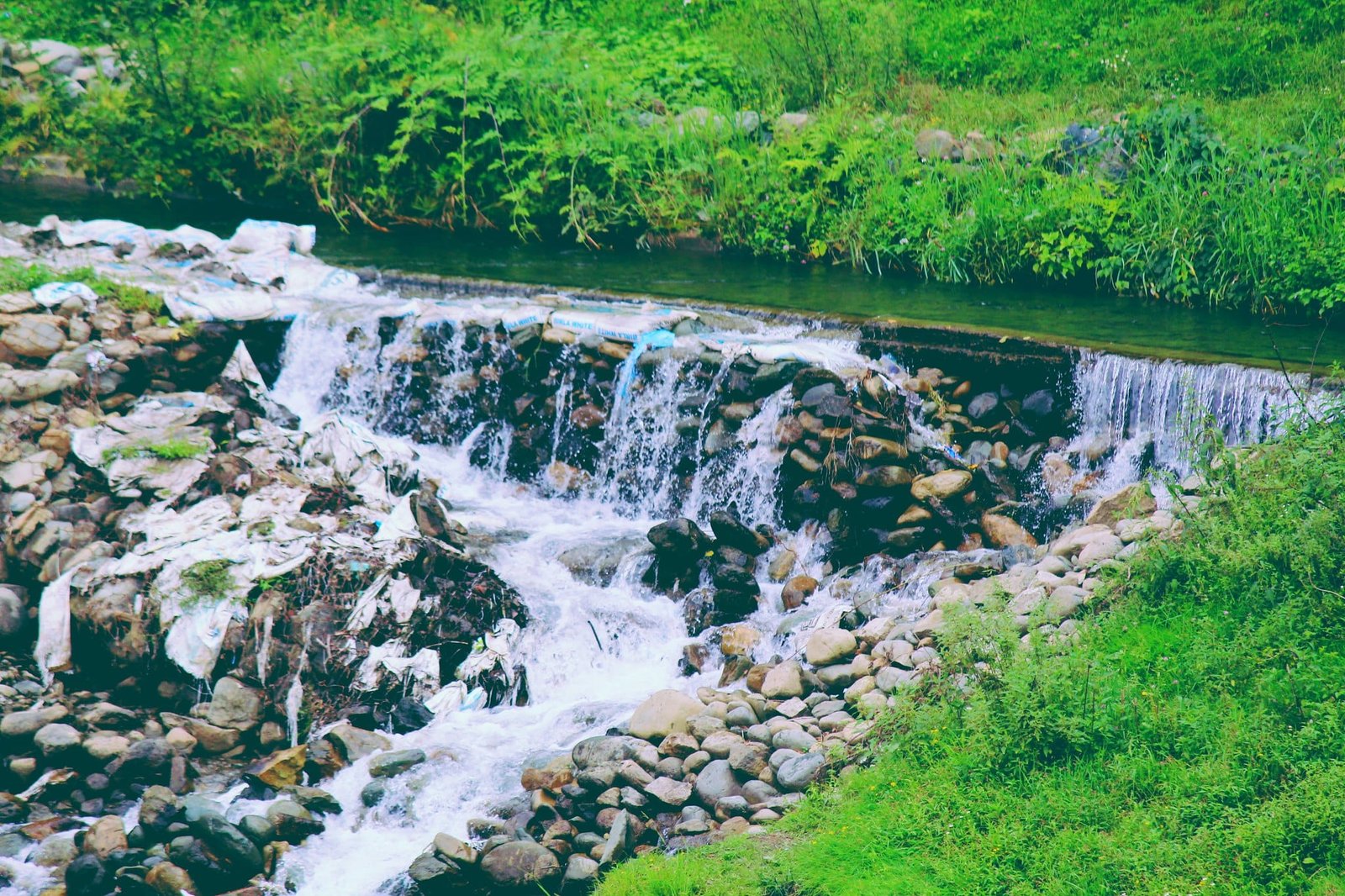 Small waterfall flowing over rocks at Doodhpathri