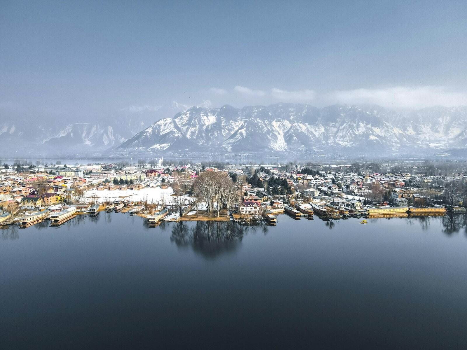 Snow-covered town near lake in srinagar