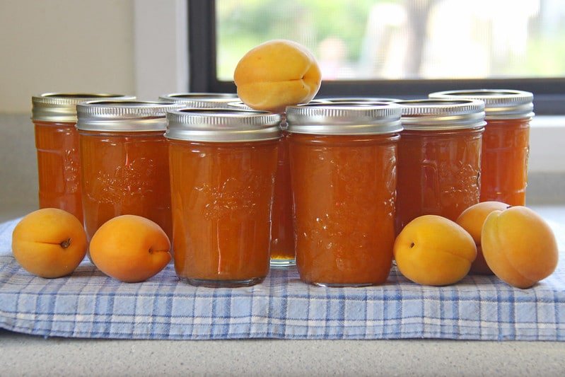 Glass jars filled with apricot jam
