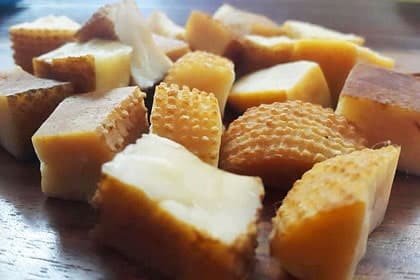 Chunks of Chhurpi cheese on a wooden surface