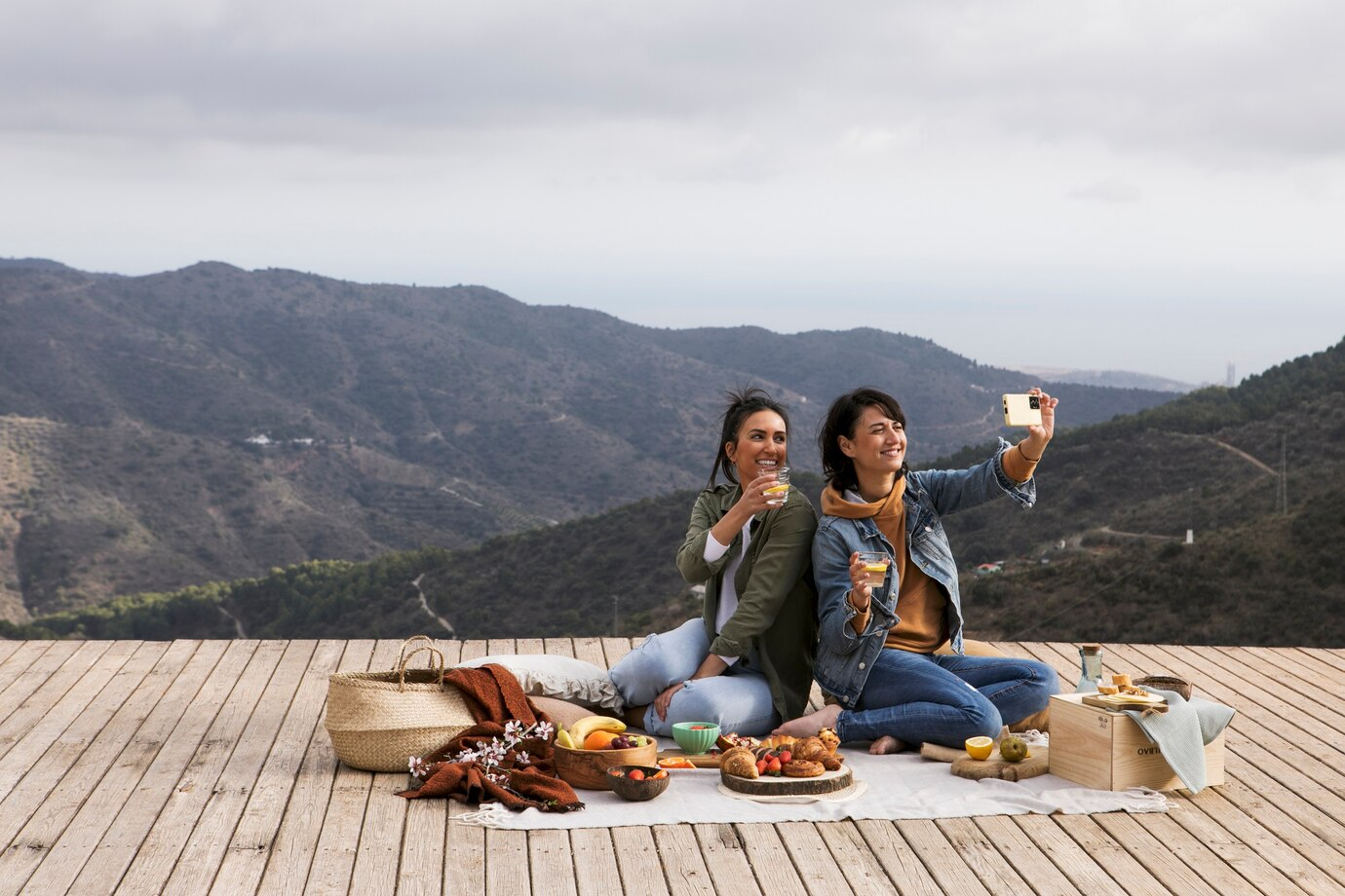 Two women taking a selfie during a picnic in patnitop, kashmir