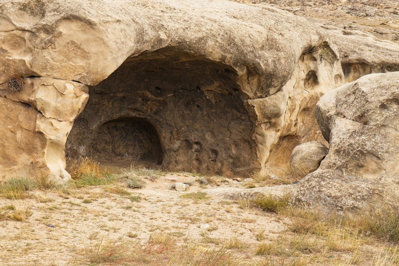 Ancient rock-cut cave entrance at Saspol Caves in Sham Valley