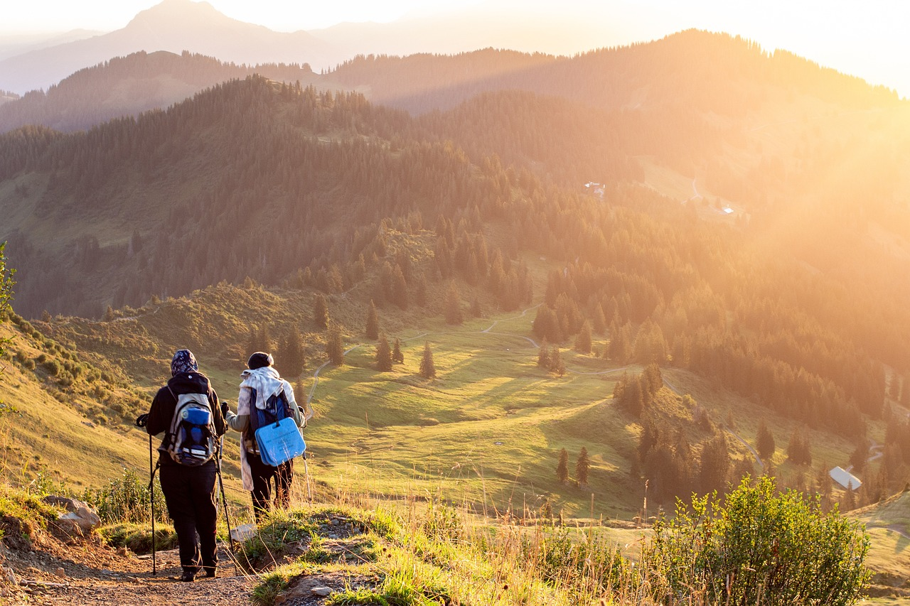 Trekkers walking through sunlit hills during Sham Valley trek in Ladakh