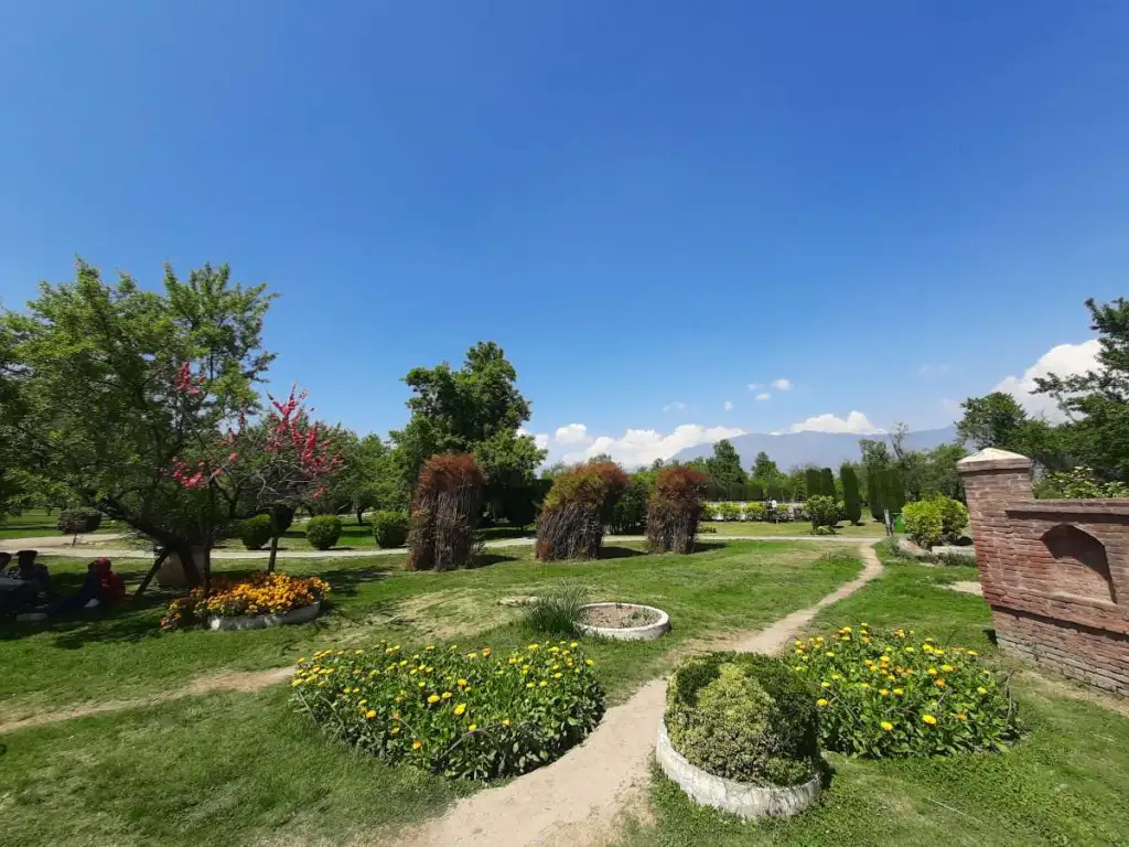 Sunny day at Badamwari Srinagar with colorful flowers, trees, and walking paths